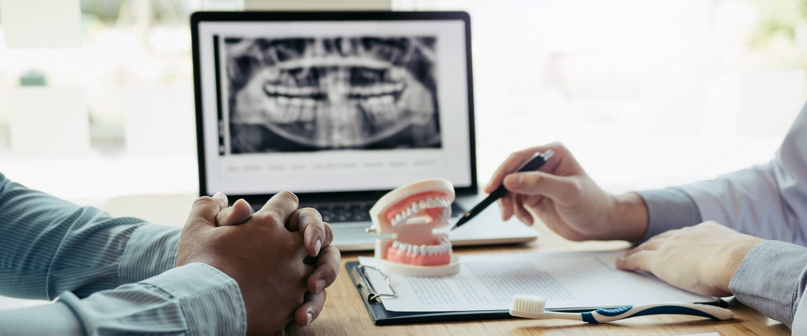 Patient consultation at MRV Dental with panoramic X-ray and treatment plan